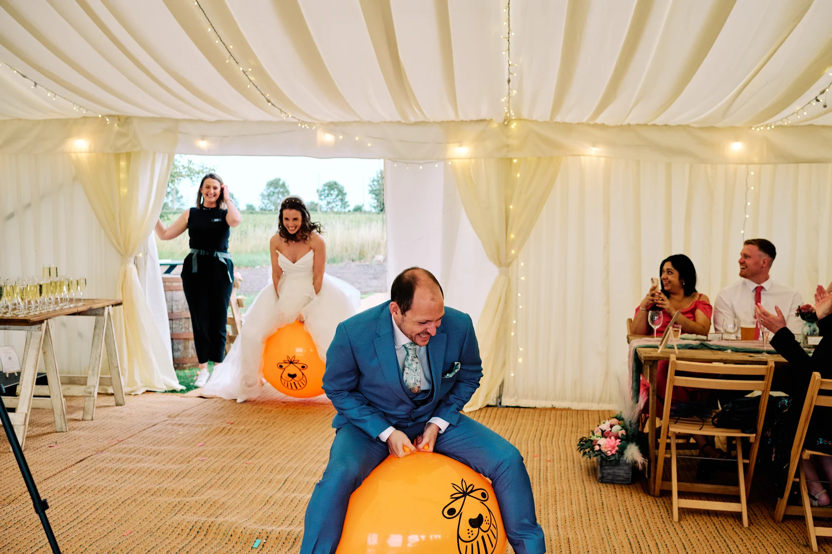 Wedding reception with bride, groom and guests enjoying fun activities and celebrations - Joyful wedding reception moments captured by Knot & Bloom wedding planning team in East Midlands